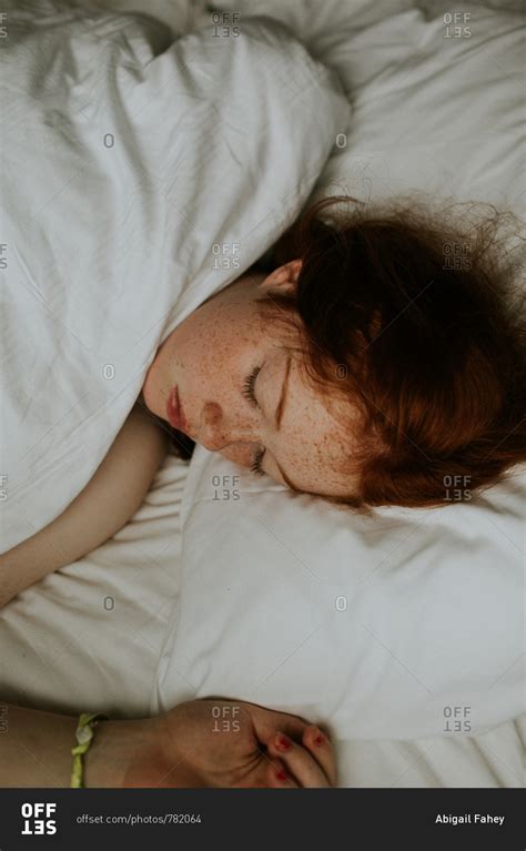 Portrait Of A Red Haired Girl With Freckles Sleeping In Her Bed Stock