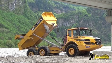 Volvo L90f Wheelloader Pushing Gravel Transported By Cat And Volvo