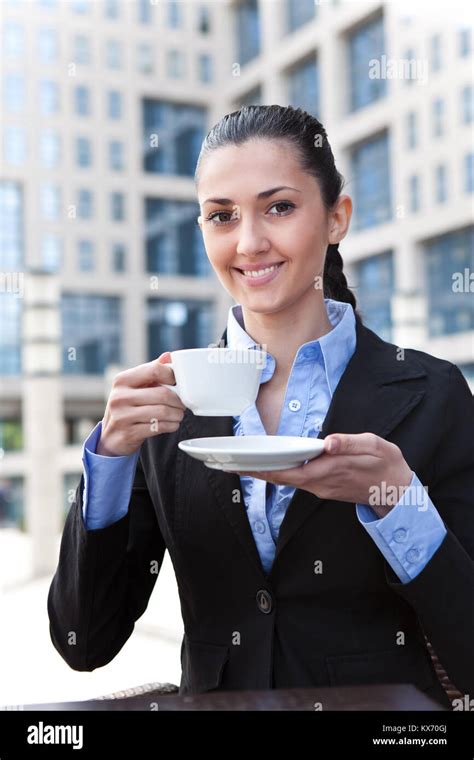 Smiling Business Lady Drinking Coffee In Business Center Stock Photo