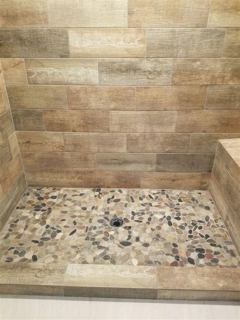 Wood Tile Shower Walls With River Rock Floor In Finished Basement