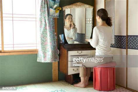 Mature Woman Applying Makeup Looking At Mirror Photo Getty Images