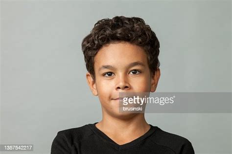 Close Up Studio Portrait Of 9 Year Old African American Boy On Gray