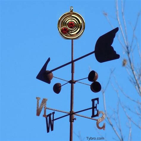A Weather Vane With Two Birds On It