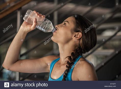 Download This Stock Image Young Woman Drinking Water From Bottle