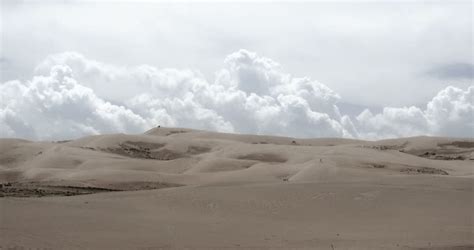 4k Timelapse Great White Puffy Cloud Mass Rolling Over Desert Sand