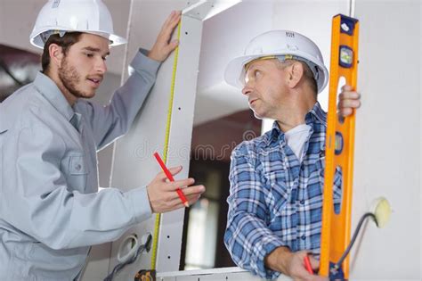 Undertaking a high standard of building repairs, maintenance and refurbishment to domestic housing… Handyman With Apprentice Working In New Home Stock Image ...
