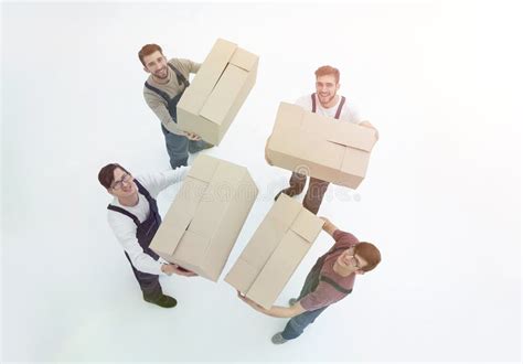 Movers Lifting Stack Of Cardboard Moving Boxes On White Stock Image