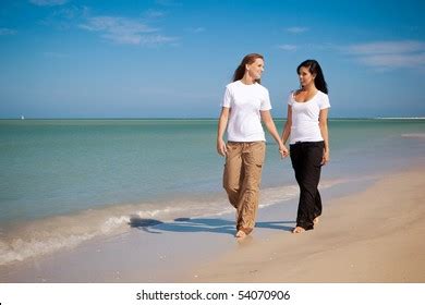 Lesbian Couple Walking On Beach Holding Stock Photo Shutterstock