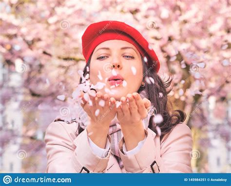 Beautiful Woman Blowing Petals In Her Hands Close Up Stock Image