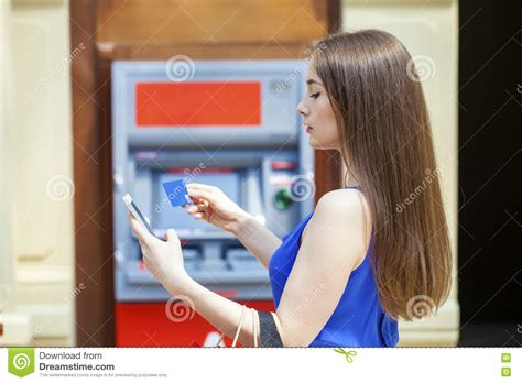 Happy Brunette Woman Withdrawing Money From Credit Card At Atm Stock
