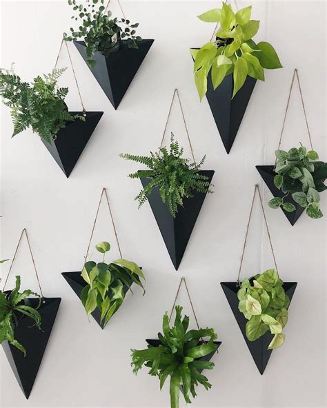 The Hanging Planters Are Made Out Of Black Triangles And Have Green