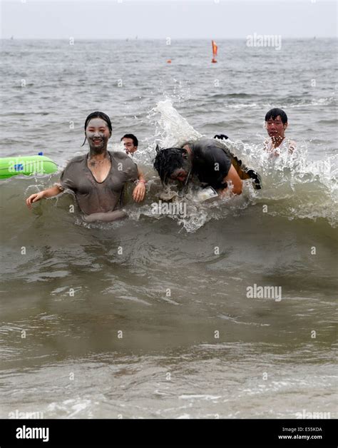 Tourists Swim After Playing In The Mud During The Boryeong Mud Festival