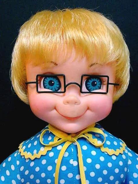 A Close Up Of A Doll With Glasses On Its Face And The Caption Happy