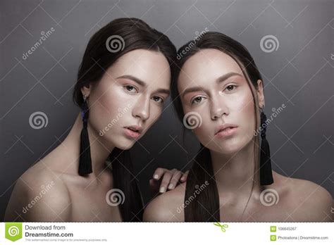 Fashion Portrait Of Two Beautiful Slim Young Girls Twins Sisters With Clear Pink Nude Natural