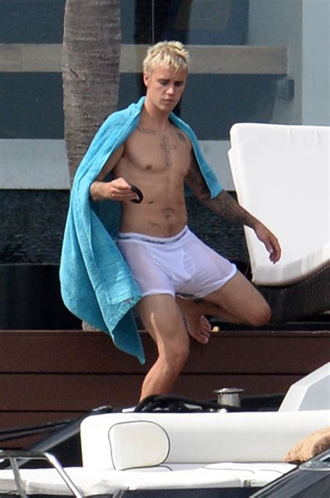 justin bieber flashes bum in soaking white pants as he gets wet and wild on fourth of july
