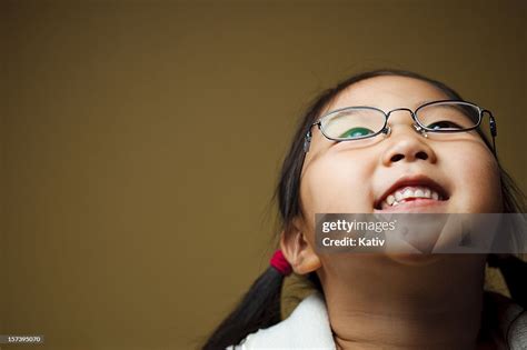Cute Girl Looking Up And Smiling High Res Stock Photo Getty Images