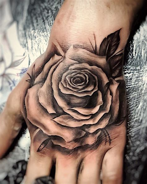 A tattoo of a rose is timeless, and depending on the color, size, number of petals, if it has thorns, or where it is placed, your rose tattoo can mean a number of things. Rose Hand Tattoo Male - Web Lanse