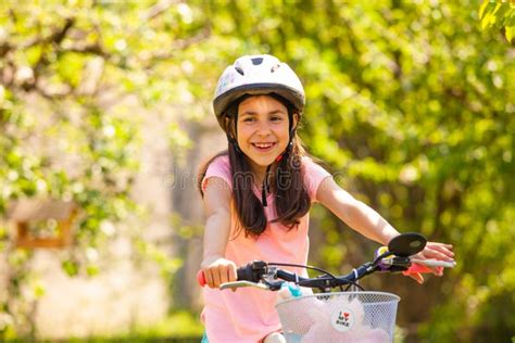Smiling Girl In Helmet Ride On The Pink Girly Bike Stock Photo Image