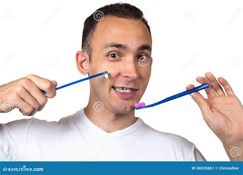 man holding two toothbrushes stock image image of choice brace 68035661