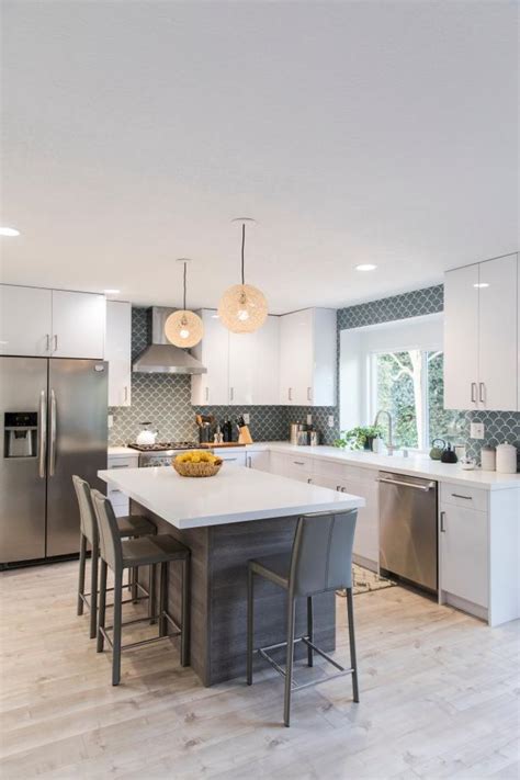 Enjoy intimate seating with style to spare. Modern White Kitchen with Gray Island and Gray Chairs | HGTV
