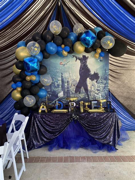 Black gold and blue decorations. Black Panther Theme main table. Black, royal blue and gold ...