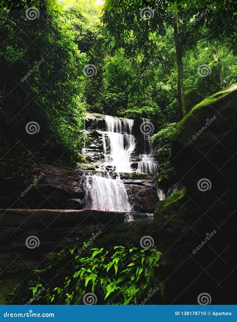 Peaceful Wide Waterfall Cascade In Dense Shady Tropical Forest Stock
