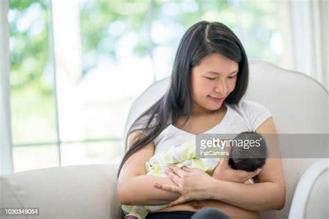Asian Mom Breastfeeding Photos And Premium High Res Pictures Getty Images
