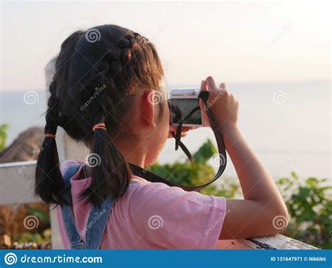 Asian Girl Holding Camera Taking A Picture With Travelling In Nature
