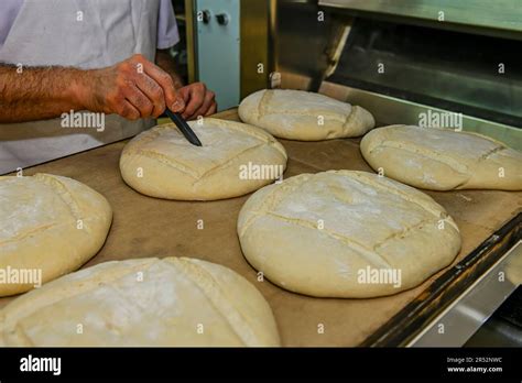 Baker kneading artisan bread in the bakery Stock Photo - Alamy