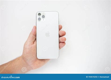 A Person Holding An Iphone 11 Pro Max On The Back Side Showing The