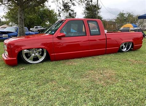 A Red Pick Up Truck Parked In The Grass