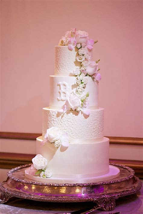 White Buttercream Wedding Cake With Cascading Roses