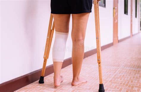 Woman Patient Using Crutches And Broken Leg For Walking At Hospital