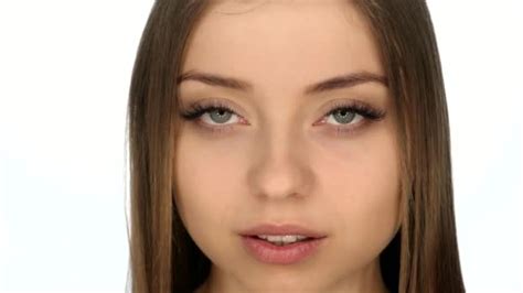 Face Closeup Of The Girl On A White Background Slow Motion 100fps — Stock Video © Sergeymalov