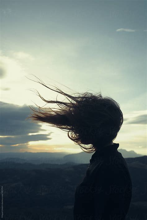 Girl S Silhouette With Her Long Hair Blowing In The Wind By Miquel Llonch Stocksy United
