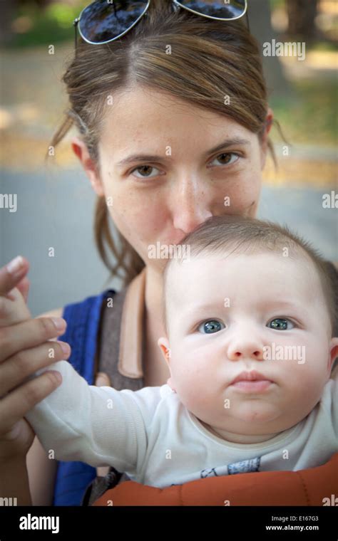 Woman Kissing On The Head Of Her Baby Boy Stock Photo Alamy
