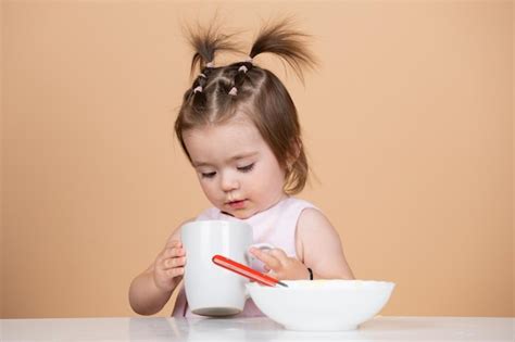 Premium Photo Cute Funny Babies Eating Baby Food Babys First Meal The