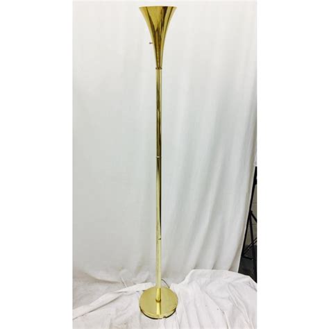It has golden both a curved pole and a round base. Vintage Mid-Century Brass Tulip Floor Lamp | Chairish