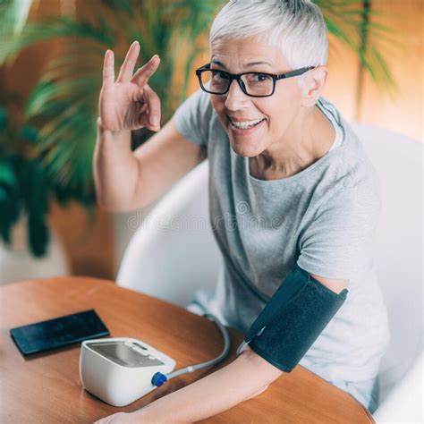 Senior Woman Measuring Blood Pressure Stock Photo Image Of Senior