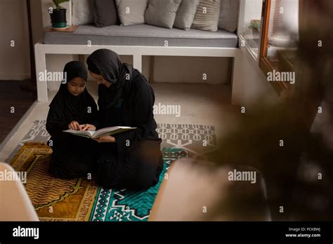 Muslim Mother Assisting Her Daughter To Read Holy Quran Stock Photo Alamy