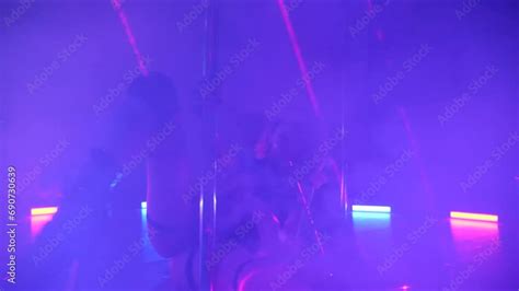 sexy woman dances a pole dance in a disco club erotic dance on a pole exotic pole dance