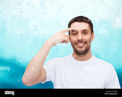 Smiling Young Handsome Man Pointing To Forehead Stock Photo Alamy
