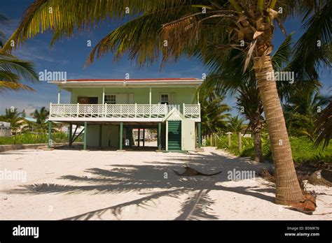Caye Caulker Belize Wooden House On Stilts On Sand Beach With Palm