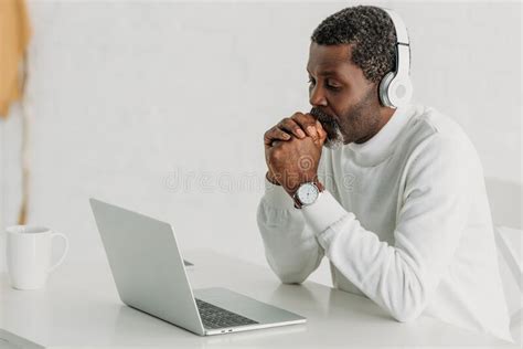 African American Man Listening Music In Headphones While Sitting Near Laptop Stock Image Image