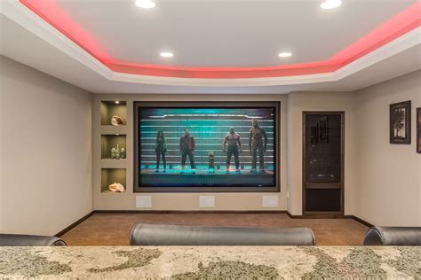 This Transitional Basement Features A Home Theater With Tv Wall Drink