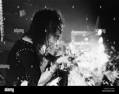American Rock Singer Alice Cooper Blows Feathers Nto The Crowd During A