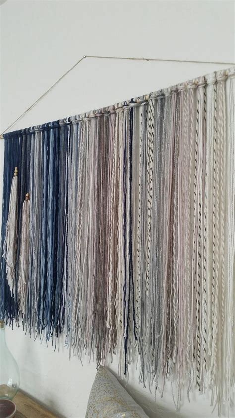 There Are Many Different Colors Of Yarn Hanging On The Wall