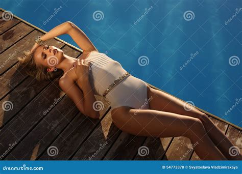 Beautiful Tanned Girl With Long Blond Hair In Elegant Swimsuit Stock Photo Image Of Pool