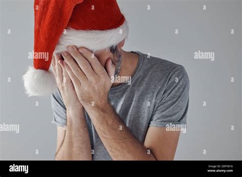 Christmas Holiday Depression Sad Sulking Man With Santa Claus Hat