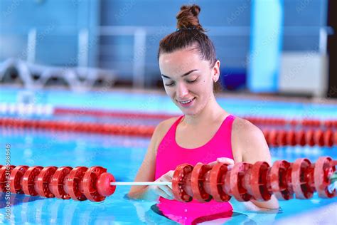 Young Swimmer Female In Swimsuit During Relaxing In Swimming Pool In